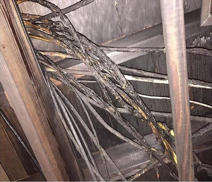 charred electrical wiring in an attic