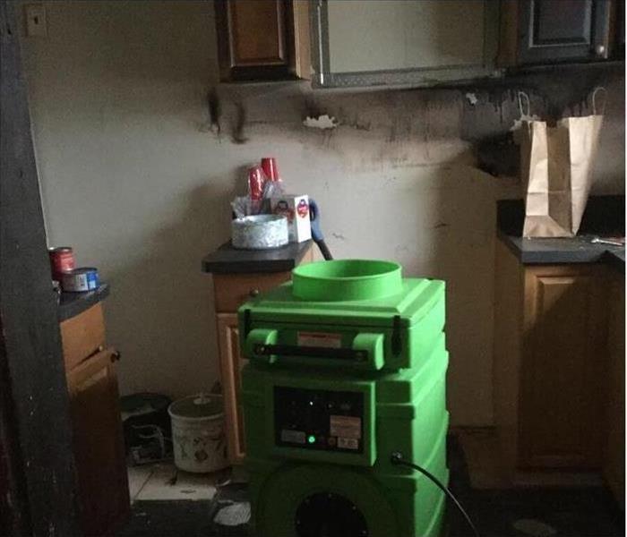 green air scrubber in a fire damaged kitchen appliances, removed