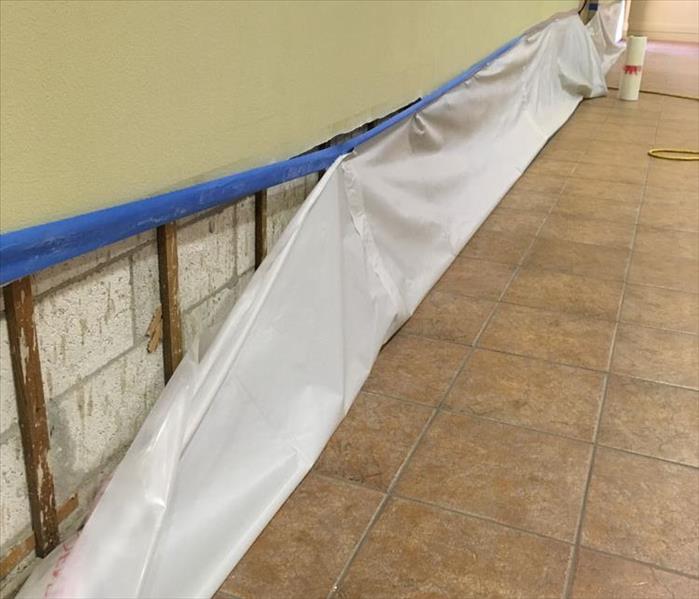 poly sheeting on flood cuts in tiled lobby