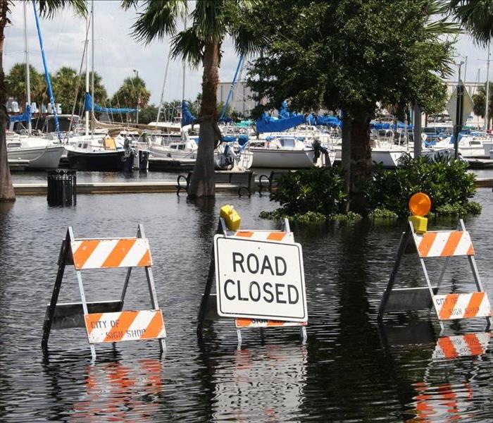 flooded roads, sign by boat docks