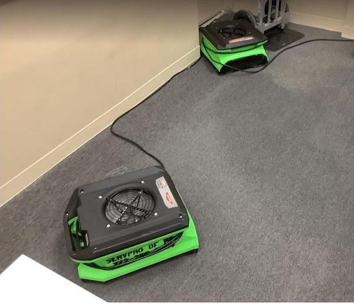 water damaged carpet; SERVPRO drying equipment being used to dry
