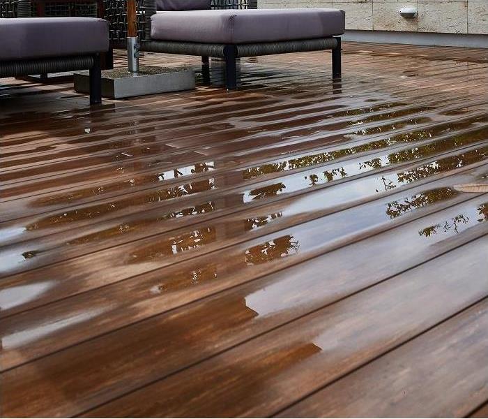 living room floor; puddling water on floor; boards cupping